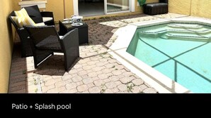 A patio with a splash pool, outdoor furniture, and a sliding glass door leading to an interior space.