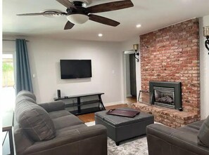 Smart TV, fireplace, books, stereo