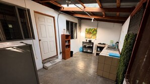 A compact kitchen with a refrigerator, sink, and cabinets. - House with excellent location in Bagaces Guanacaste (Salitral)