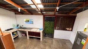 A compact kitchen with a wooden countertop, a sink, and a refrigerator. - House with excellent location in Bagaces Guanacaste (Salitral)