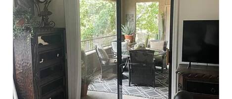 A room with a sliding glass door leading to an outdoor patio area.