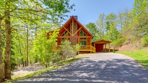 A cabin with a stone chimney, wooden deck, and a covered porch. - Great for Families! Lavish Hiawassee Cabin (Hiawassee)