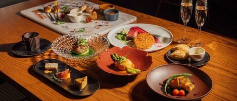 A dining table with various dishes and drinks.