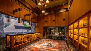 A spacious lobby with a large, ornate rug, wooden paneling, and a reception desk. - Mercure Hida Takayama (Takayama)