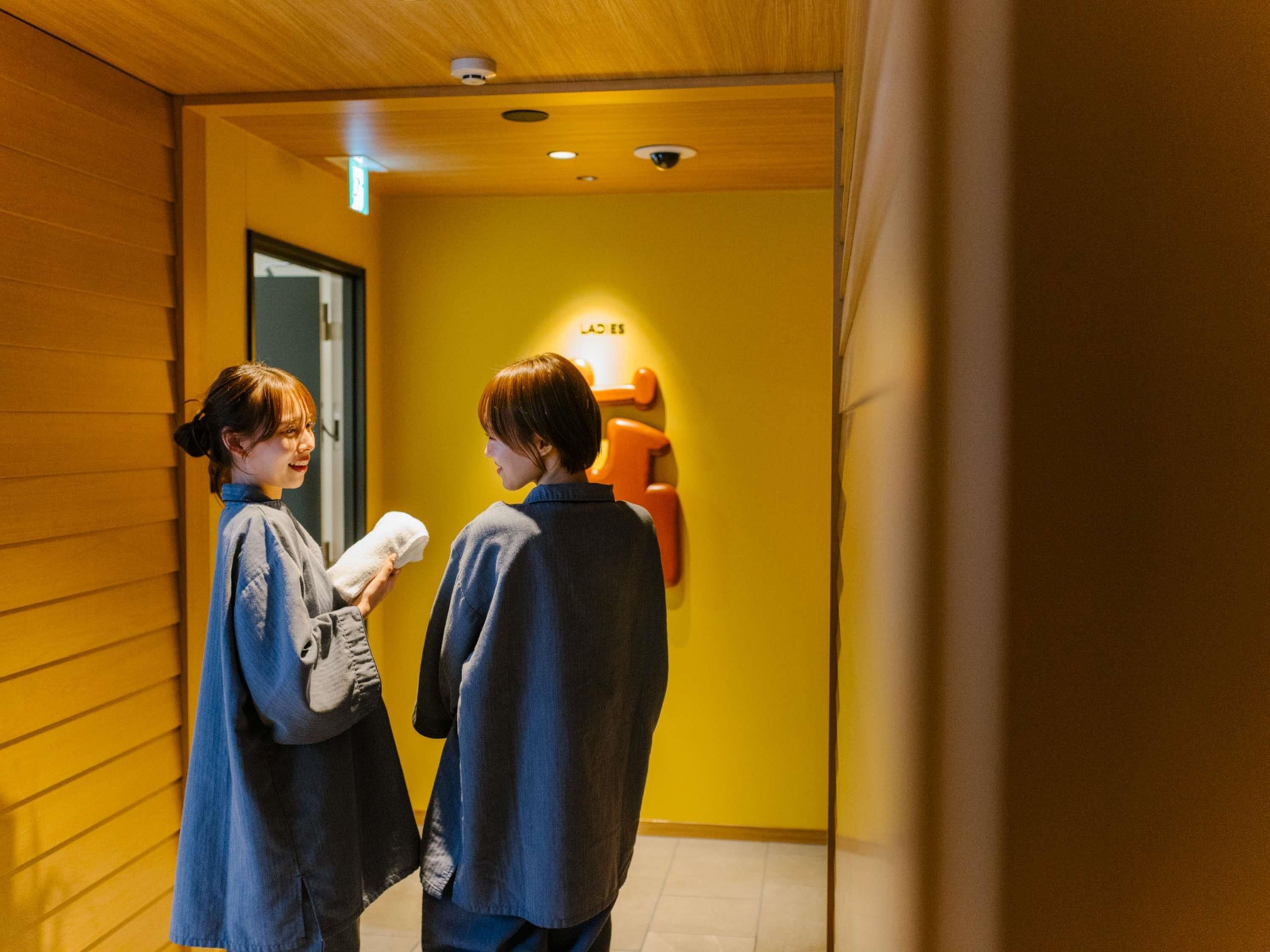 A hallway with wooden walls and a yellow accent wall.