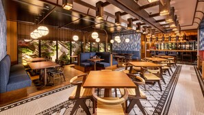 A restaurant with wooden tables and blue seating, large windows, and hanging pendant lights. - Mercure Hida Takayama (Takayama)