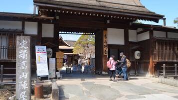 A traditional Japanese gate with stone steps leading up to it.