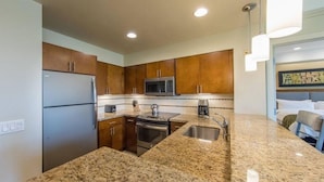 A modern kitchen with granite countertops, stainless steel appliances, and wooden cabinets. - Marriott Shadow Ridge Villages # 4 (Palm Desert)