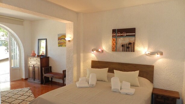 A bedroom with a large bed, a desk, and a chair. - Villa Tina para 8 personas (Calpe)