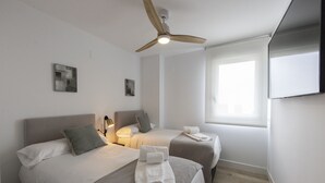 A hotel room with two beds, a ceiling fan, a TV, and a window with blinds. - Ref. 396309 (Motril)
