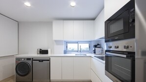 A modern kitchen with stainless steel appliances, white cabinetry, and a built-in oven. - Ref. 396309 (Motril)