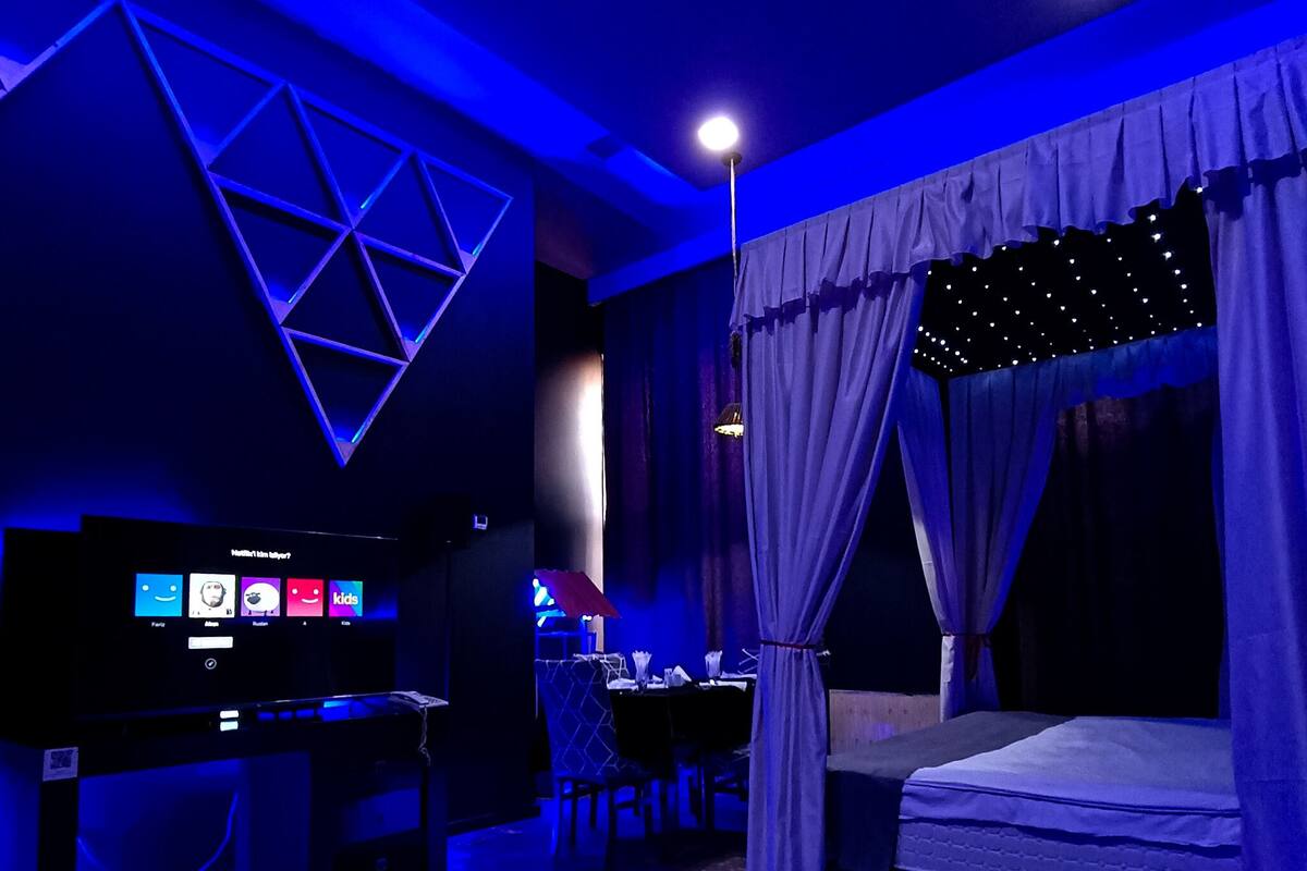 A room with a bed, a desk, and a TV.