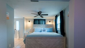 A bedroom with a bed, a ceiling fan, and a nightstand. - Endless Summer Pool Vibes (Largo)