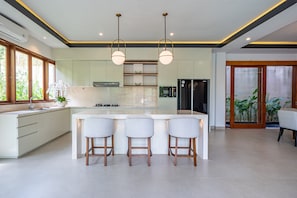Fridge, electric kettle, cookware/dishes/utensils, dining tables