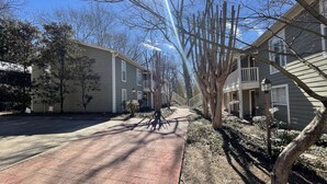 A residential street with two-story houses, a brick pathway, and trees. - LOCATION!! LOCATION!! LOCATION!! (Oxford)