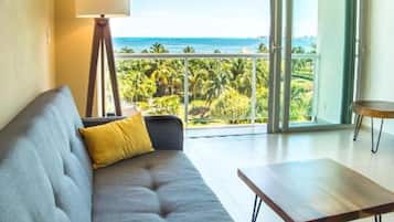 Deluxe Apartment, 2 Bedrooms, Partial Sea View, Beachside | Living area | 42-inch Smart TV with cable channels