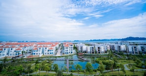 A resort with multiple buildings, a central courtyard, and a body of water.