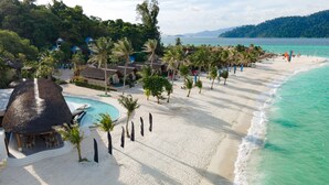 A beach resort with a pool, palm trees, and beach huts. - Irene Pool Villa Resort, Koh Lipe (Koh Lipe)