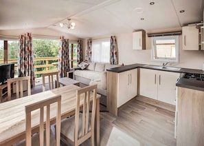 A compact kitchen with a dining area, a sofa, and a TV. - The Maple is designed to give you an all inclusive spec at an affordable price. (Tenbury Wells)