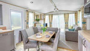 A compact living space with a dining area, kitchenette, and seating area. - Thoughtfully designed for comfort and style. (Withernsea)