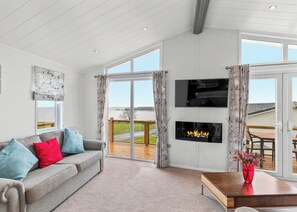 Living area - Stunning lodge with one double with en suite walk in shower and two twin. (Summerhill, Amroth)