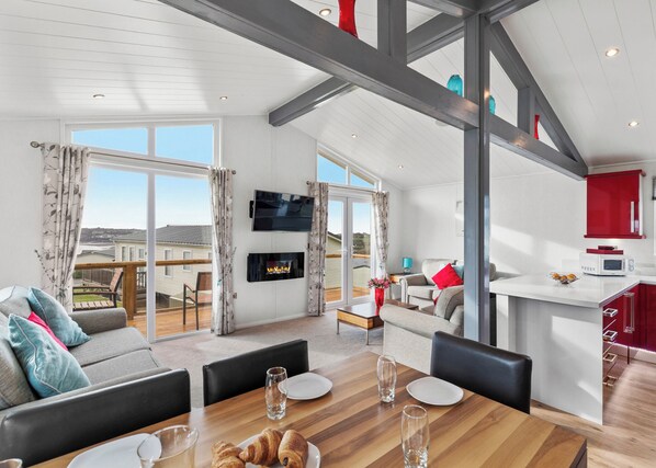 Living area - Stunning lodge with one double with en suite walk in shower and two twin. (Summerhill, Amroth)