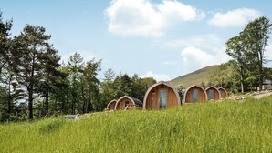 A row of wooden dome-shaped cabins with a natural landscape in the background. - 1 bedroom accommodation in Troutbeck (Troutbeck)