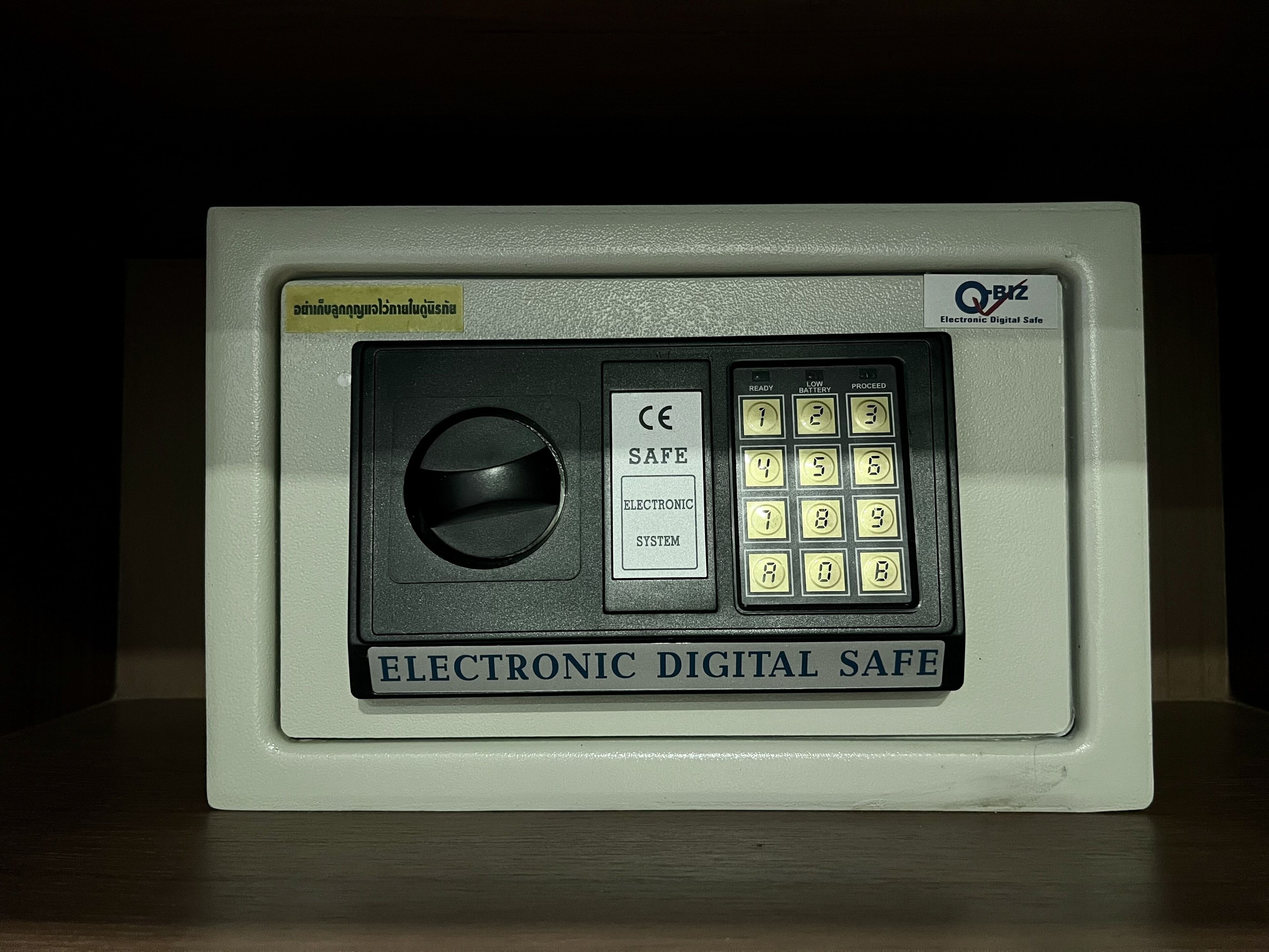 An electronic digital safe with a keypad and a lock button.