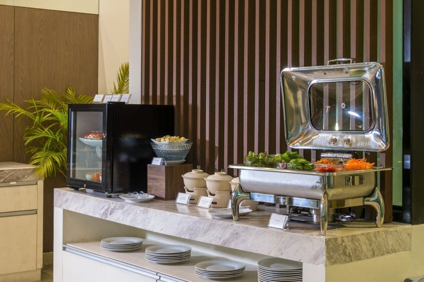 A buffet setup with a glass display case, a buffet station, and a variety of dishes.