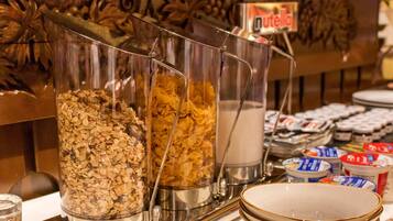 A buffet with various food items including cereals and spreads.