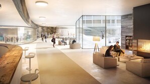 Een moderne lobby met een gebogen houten receptiebalie, zitgedeeltes en een open haard.