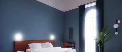 Un dormitorio con cama, escritorio, silla, planta en maceta y una ventana grande.