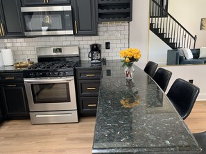 Enjoy cooking in this kitchen with stainless steel appliances, a granite countertop, and a microwave, stove, and oven.