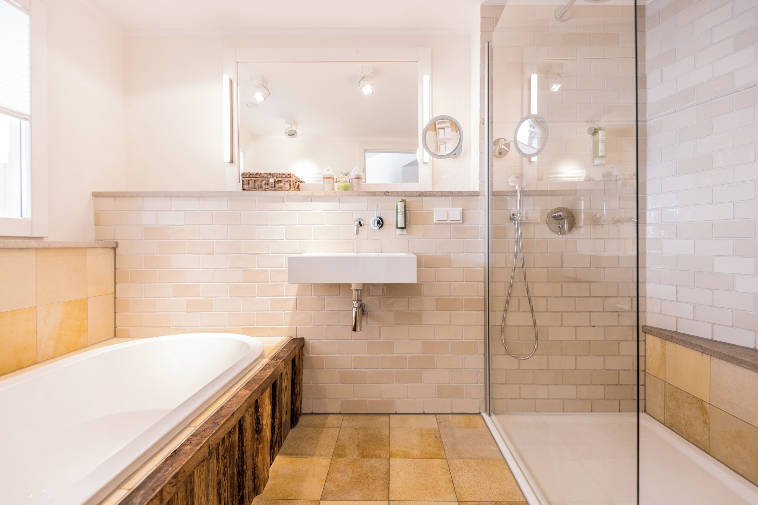 A modern bathroom with a bathtub, a sink, and a glass shower enclosure.
