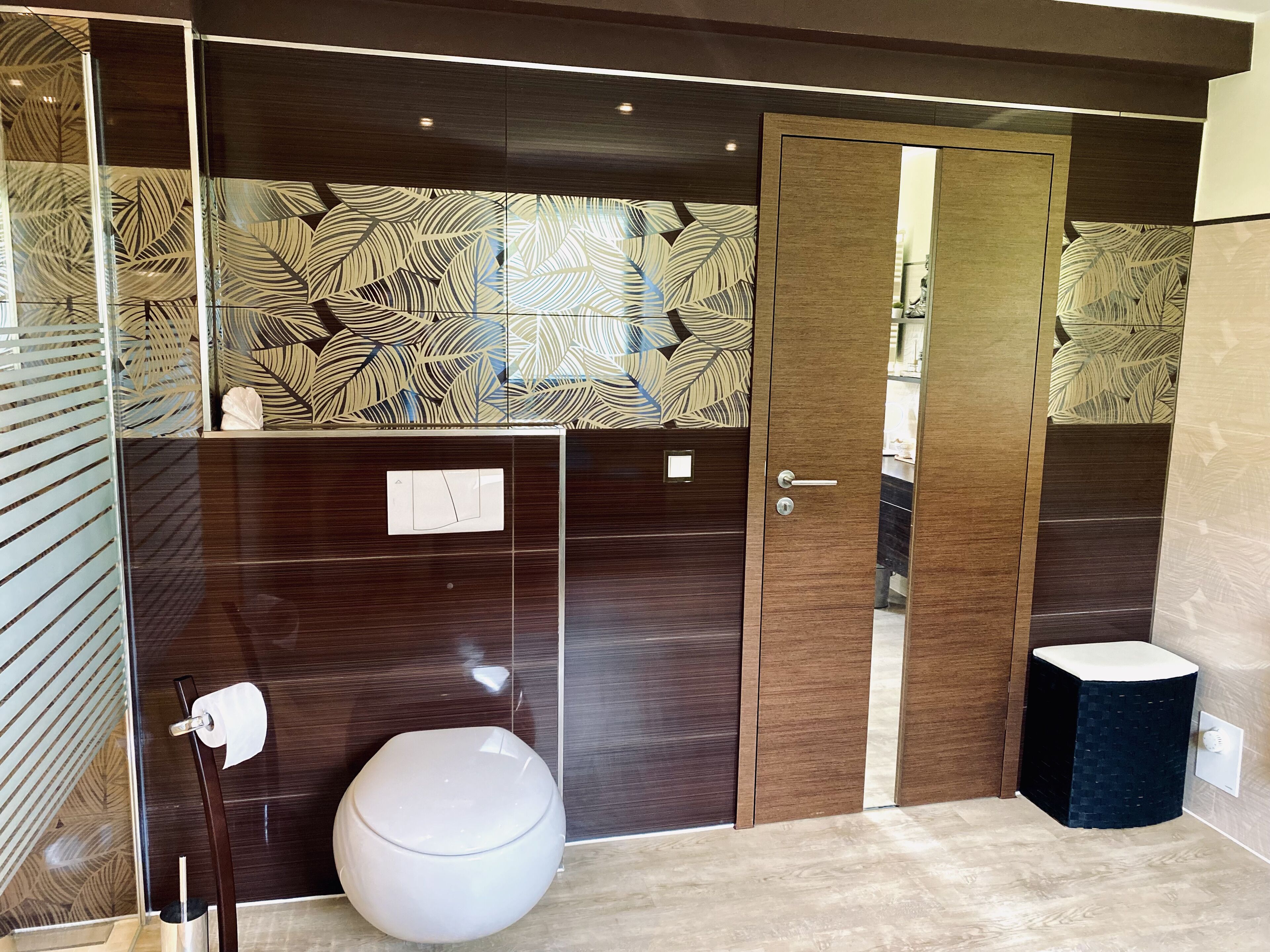 A modern bathroom with a toilet, a bidet, and a sink.