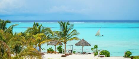 Private beach, white sand, sun loungers, beach umbrellas