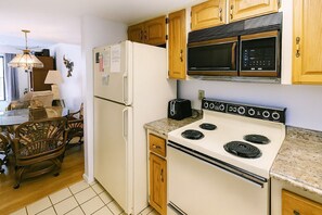 Microwave, dishwasher, coffee/tea maker, cookware/dishes/utensils - Daytona Beach Getaway – Pool View, Gated Complex, 2-Min Stroll to the Ocean (Daytona Beach Shores)