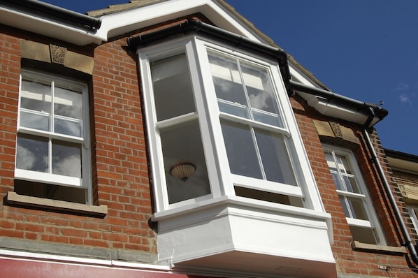 A corner of a brick building with a bay window and a dormer window. - The Hideaway, Aldeburgh (Aldeburgh)