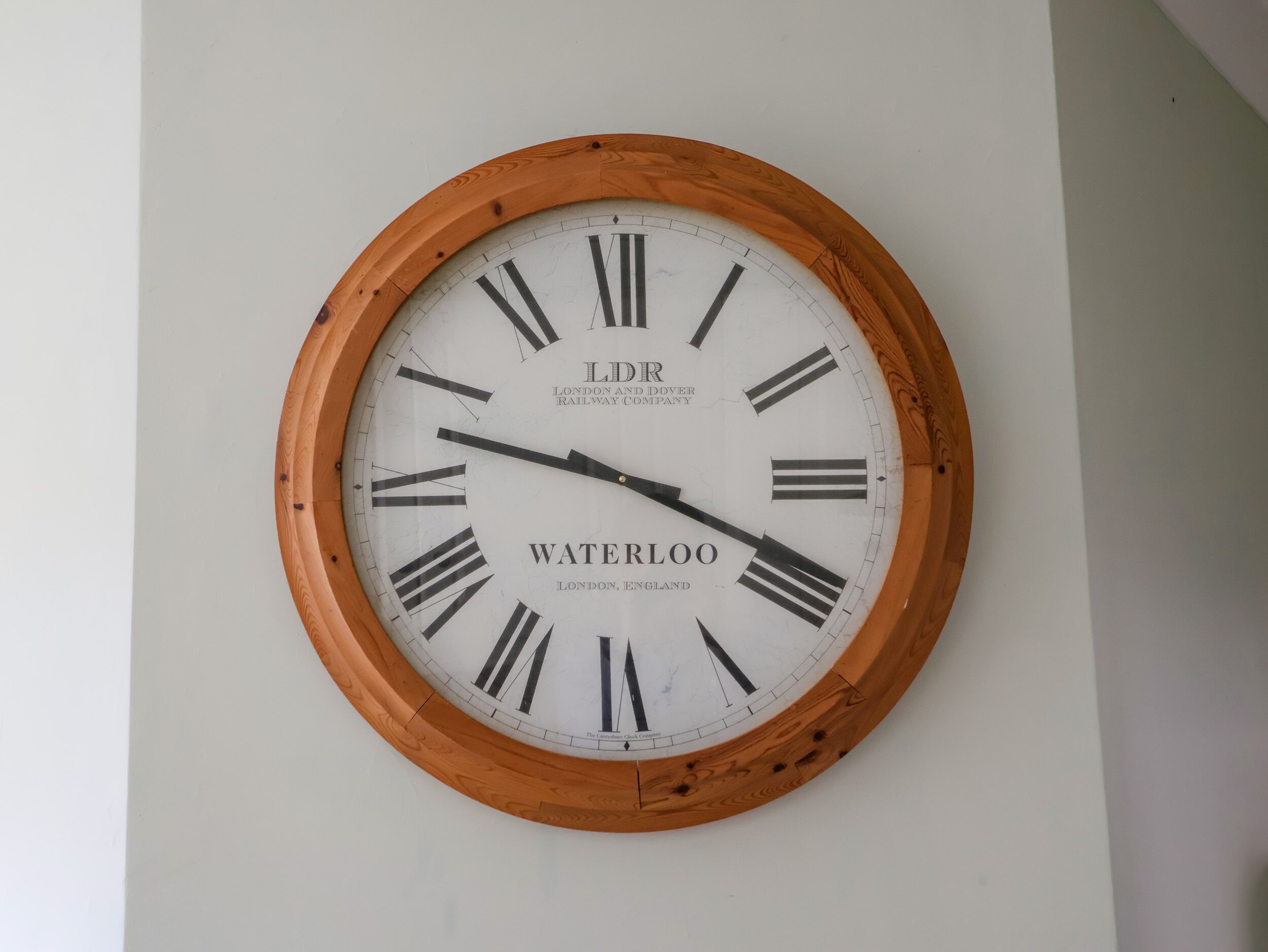A round wall clock with Roman numerals and the text "LDR London and Dover Railway Company" and "Waterloo, London, England" on its face.