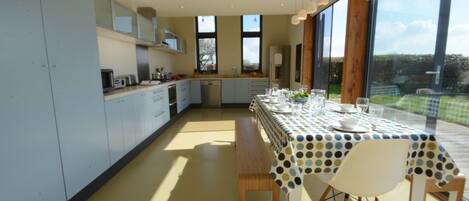 A modern kitchen with a dining area.