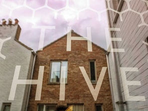 A narrow street with a brick building and a white building on either side. - The Hive, Southwold (Reydon)