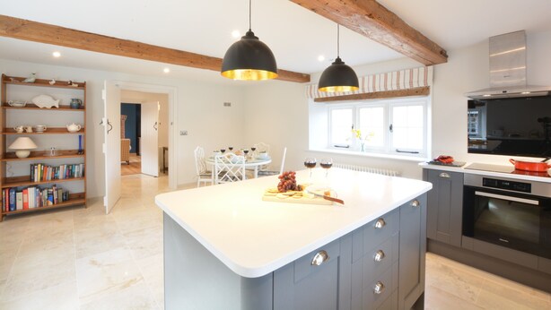 A modern kitchen with a central island, pendant lighting, and a built-in oven. - Woodland Cottage, Great Glemham (Saxmundham)