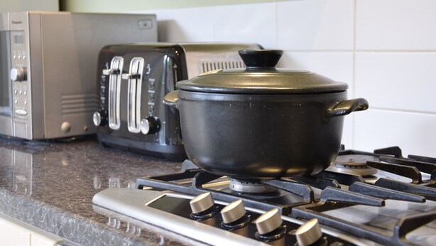A kitchen with a stove, a toaster, and a pot on the counter. - 14 Dunwich Road, Southwold (Reydon)