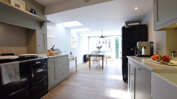 A kitchen with a dining area, wooden flooring, and a view to the outside. - 15 Victoria Street, Southwold (Reydon)