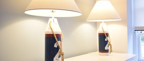 Two lamps with nautical-themed designs on a white surface.