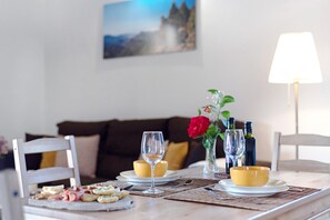 A dining table with a glass, two bowls, and a plate of appetizers. - Accessible Holiday Home 'El Algarrobero' with Mountain Views and Private Pool (Rosiana)