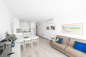 A modern apartment with a kitchen, dining area, and living room.