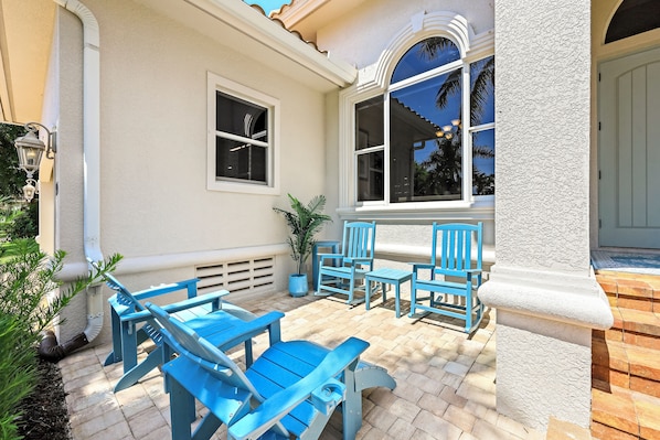 A patio with blue furniture and a potted plant.