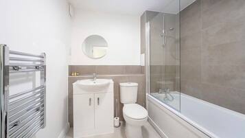 Shower, hair dryer, towels, shampoo