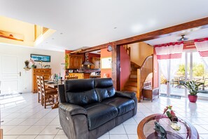 Relax in this inviting living area with a sofa, dining table, and kitchenette.